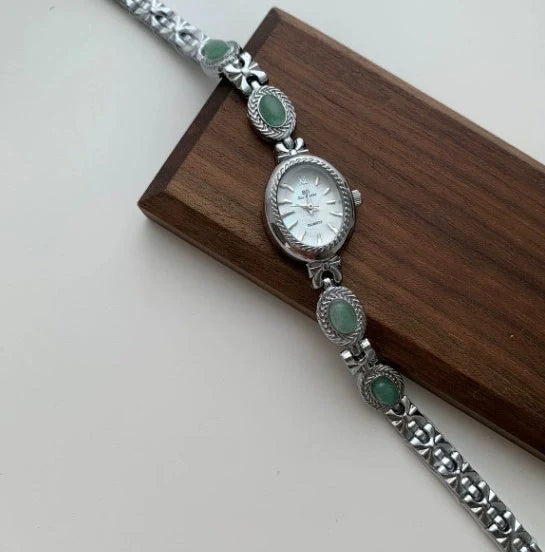 Green jade and silver ladies watch with white dial showing modern Chinese design