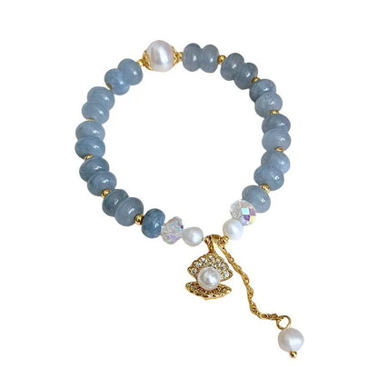 Natural aquamarine pearl bracelet with abalone shell charms on adjustable cord