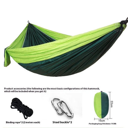 Parachute cloth double camping hammock in chosen colour, with black buckles and round ropes on a tree.