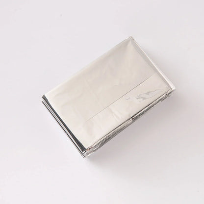 Portable double-sided silver emergency thermal blanket for outdoor adventures and survival situations