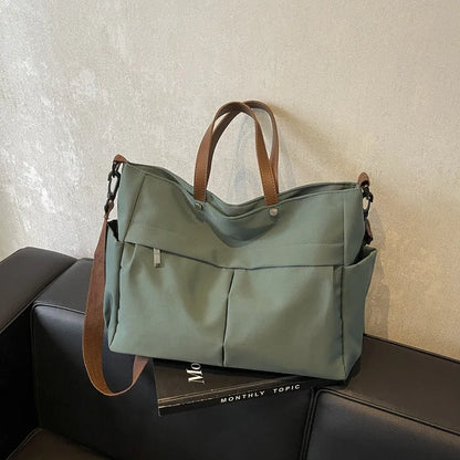 Nylon crossbody bag in five colours with 39x14x28cm dimensions and shoulder strap