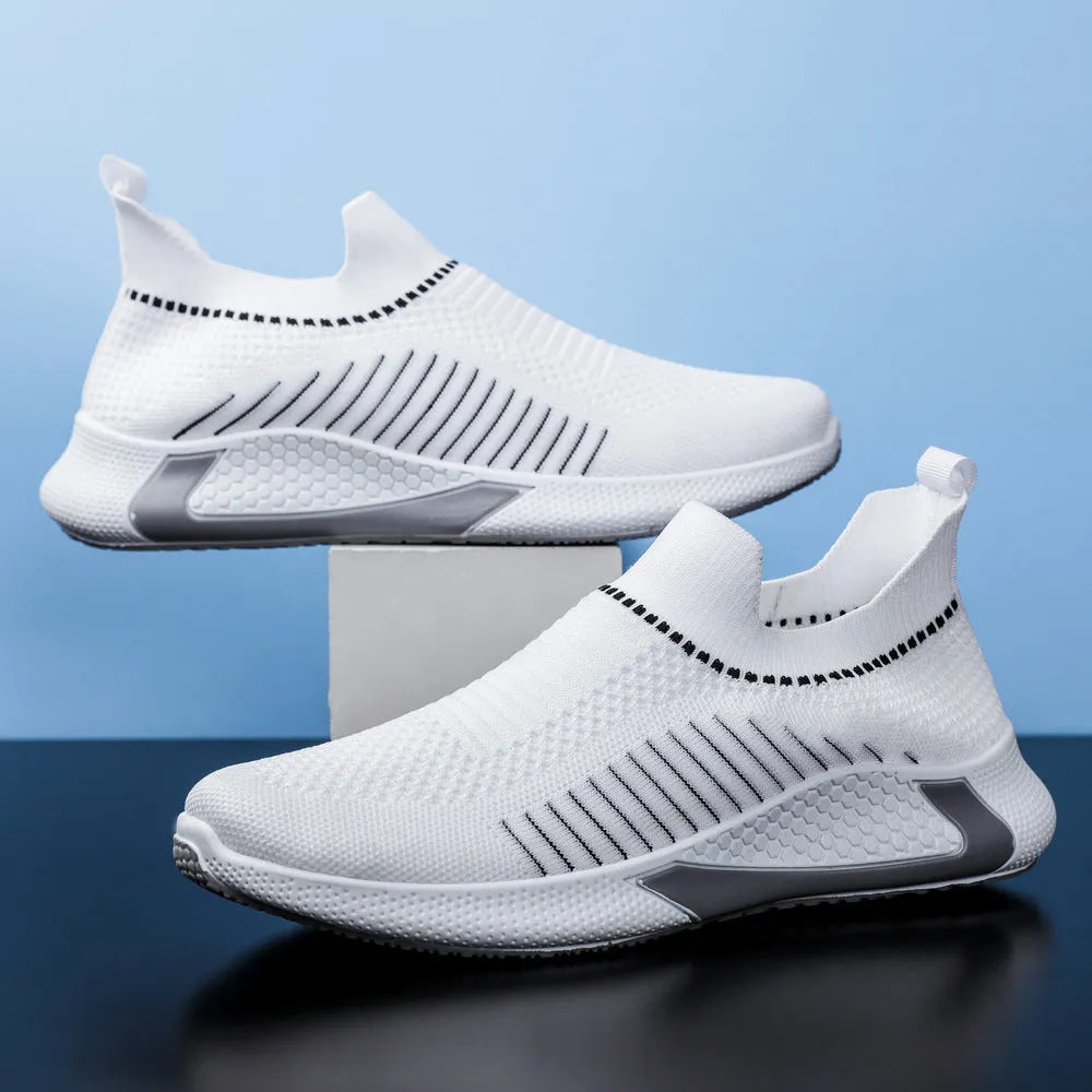 Men's black and white striped slip-on sneakers with lace-up front and mesh upper.