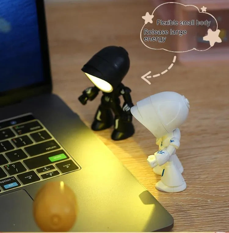 Mini mecha robot hero LED night light with adjustable arms on a desk.