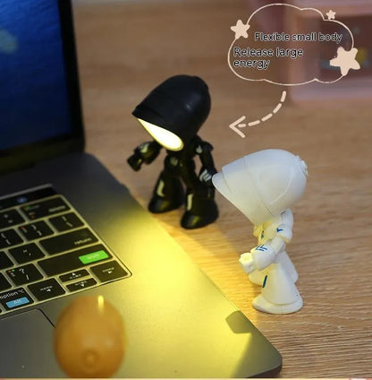 Mini mecha robot hero LED night light with adjustable arms on a desk.