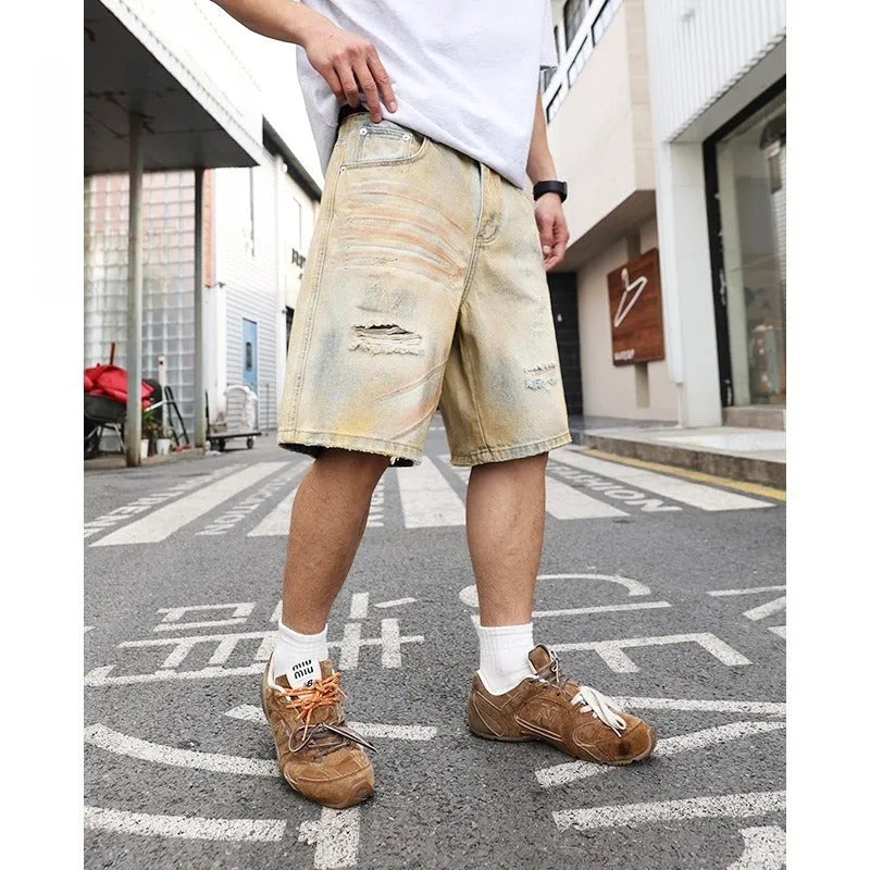 Men's light blue denim shorts with distressed finish and straight-leg silhouette
