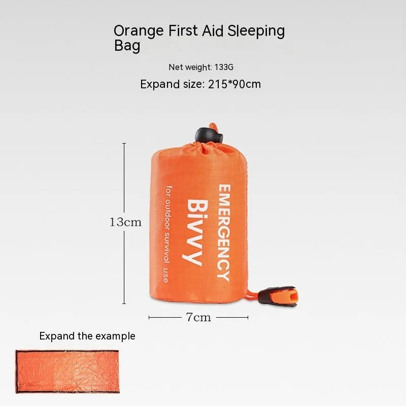 Orange emergency tent with sleeping bag and blanket disaster relief kit on ground