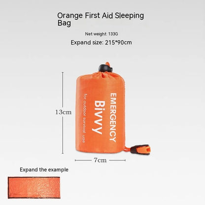 Orange emergency tent with sleeping bag and blanket disaster relief kit on ground
