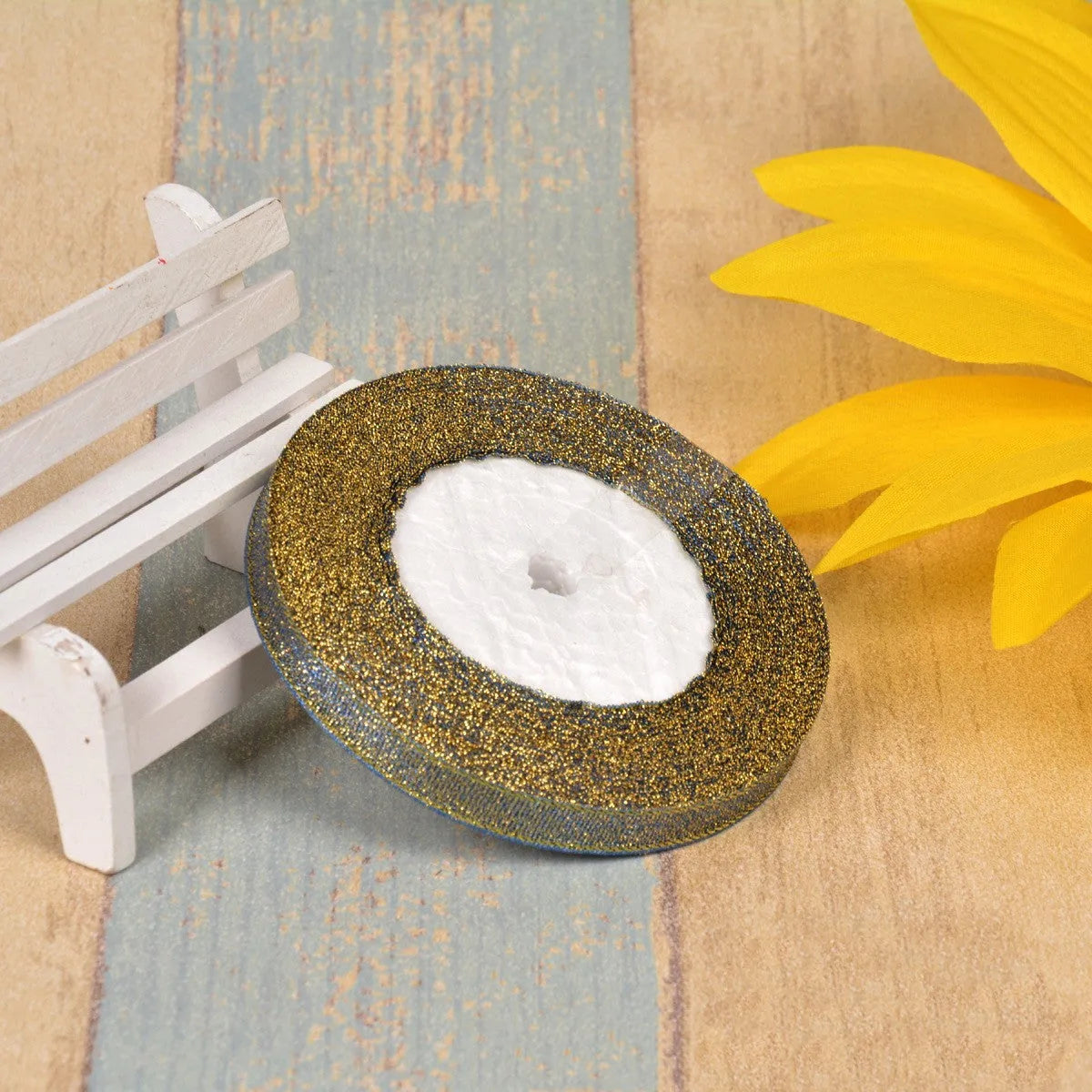 Close-up of green onion patterned ribbon with gold wire on a 25-yard roll, showing 3-points width.
