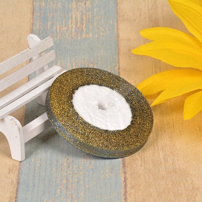 Close-up of green onion patterned ribbon with gold wire on a 25-yard roll, showing 3-points width.