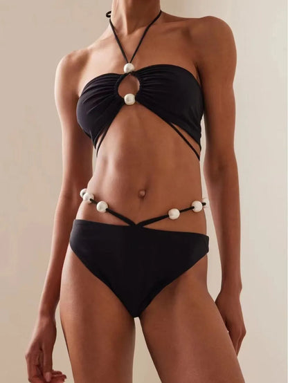 Women's black lace-up bikini swimsuit showing adjustable design and two-piece construction