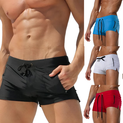 Men's black high-waisted swimming trunks with a lace-up front closure, shown on a model.