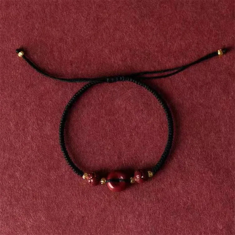 Cinnabar heart-shaped bracelet with safety buckle closure and adjustable coloured rope in traditional Chinese design