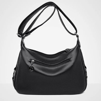 Large blue women's shoulder bag with crossbody strap and multiple internal compartments