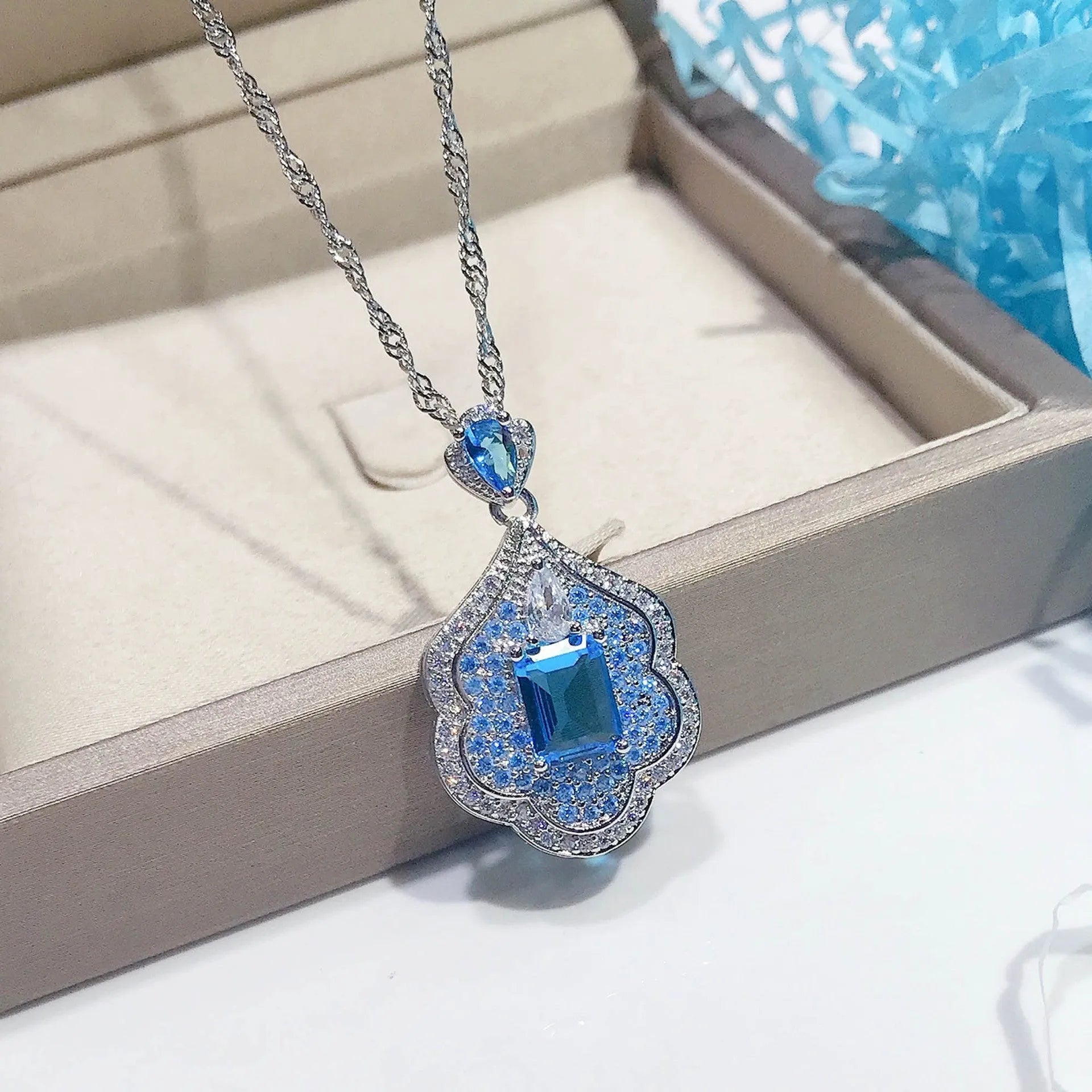 Geometric sea blue copper pendant charm on a white background.