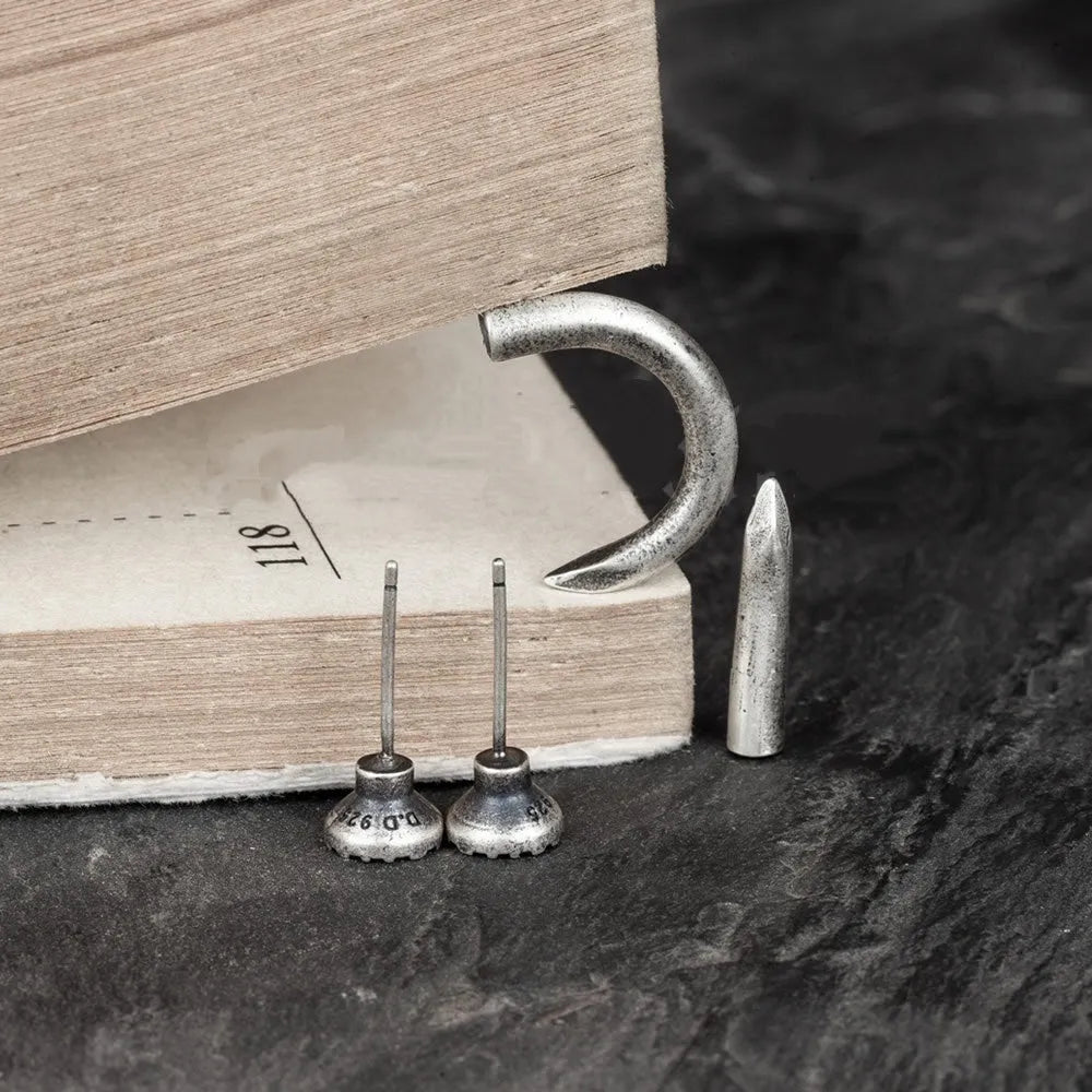 Sterling silver nail stud earrings showing straight and curved punk retro styles