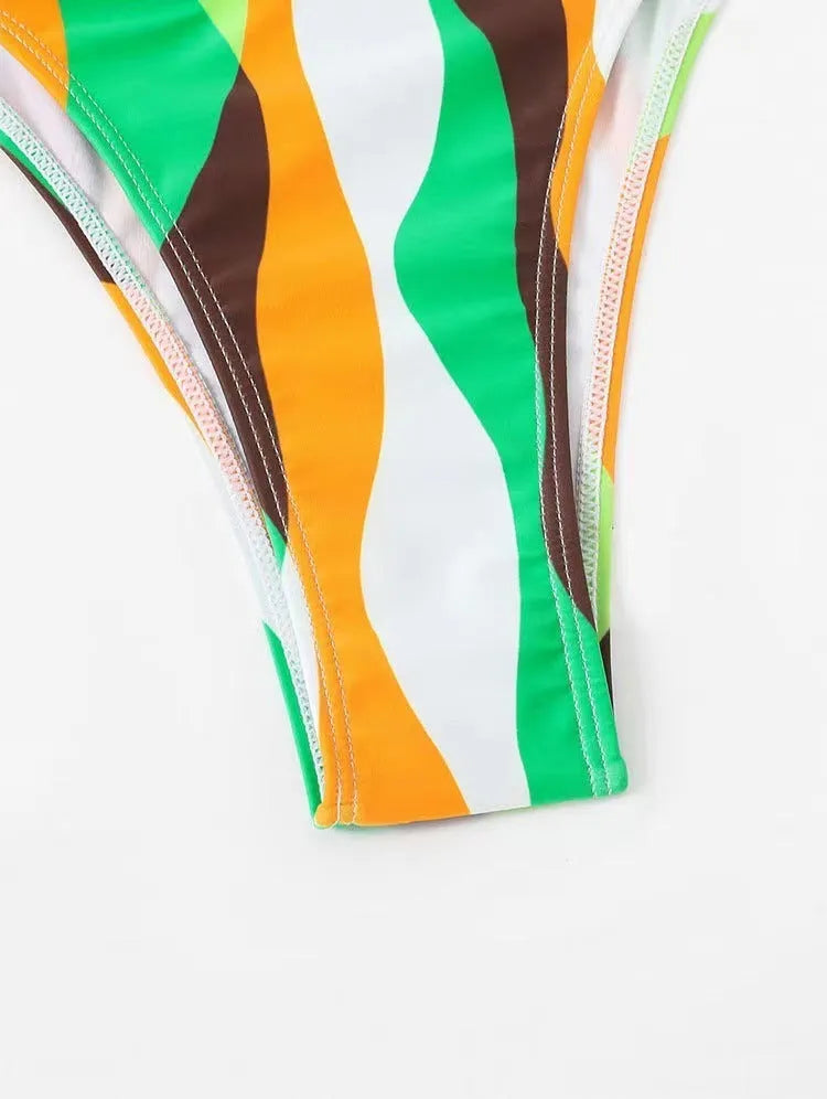 Women's three-piece swimwear set showing bikini top, briefs and printed beach skirt in polyester fabric