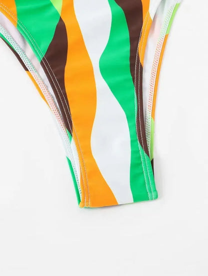 Women's three-piece swimwear set showing bikini top, briefs and printed beach skirt in polyester fabric