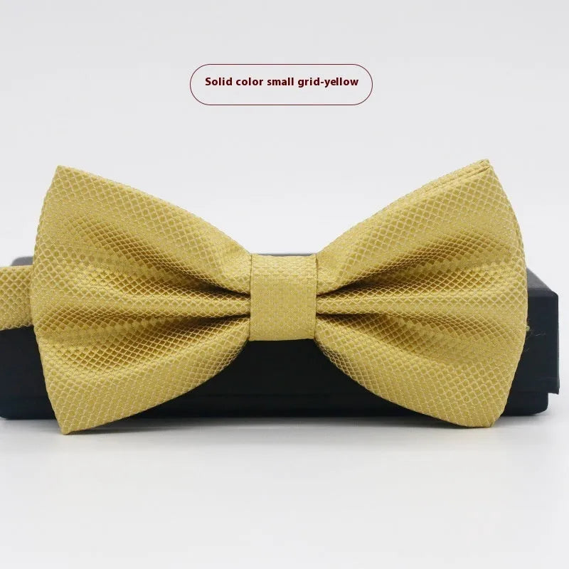 A solid colour pre-tied bow tie with an adjustable neck strap, shown in a classic flat head shape.