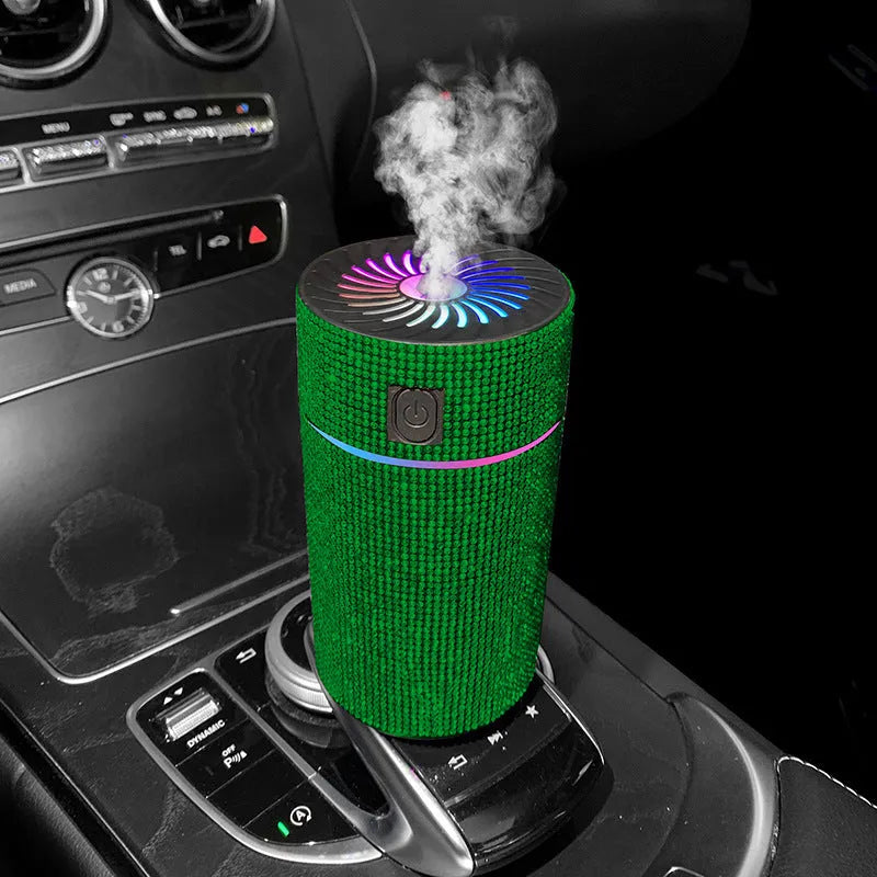 Compact white car air purifier and humidifier unit with USB cable on a car dashboard.