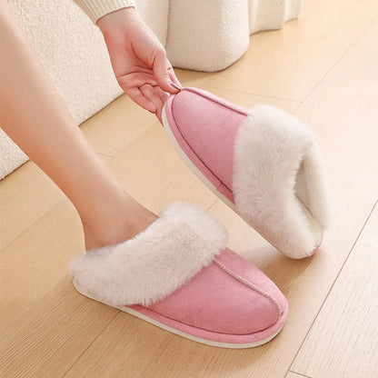 Women's plush winter slippers with round toe, flat heel, and stitching detail on a non-slip PVC sole.