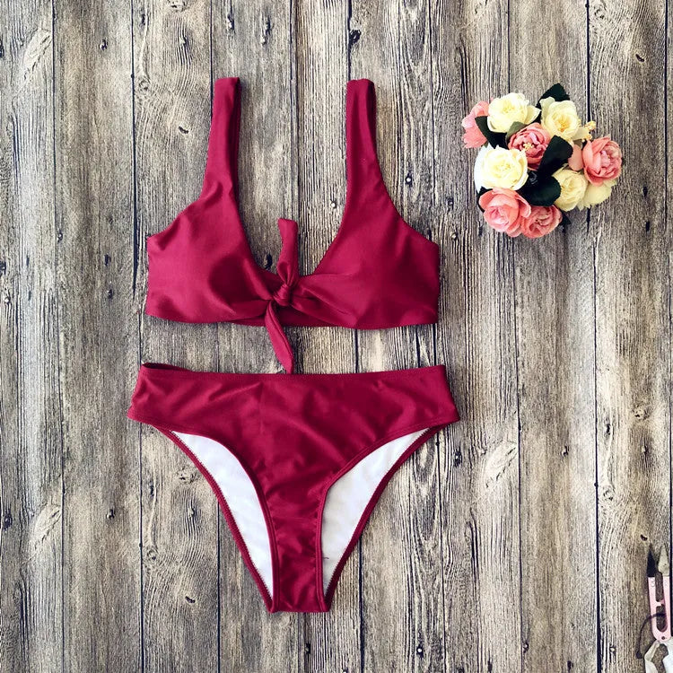 Women's solid colour bikini set with sleeveless top and briefs on a neutral background