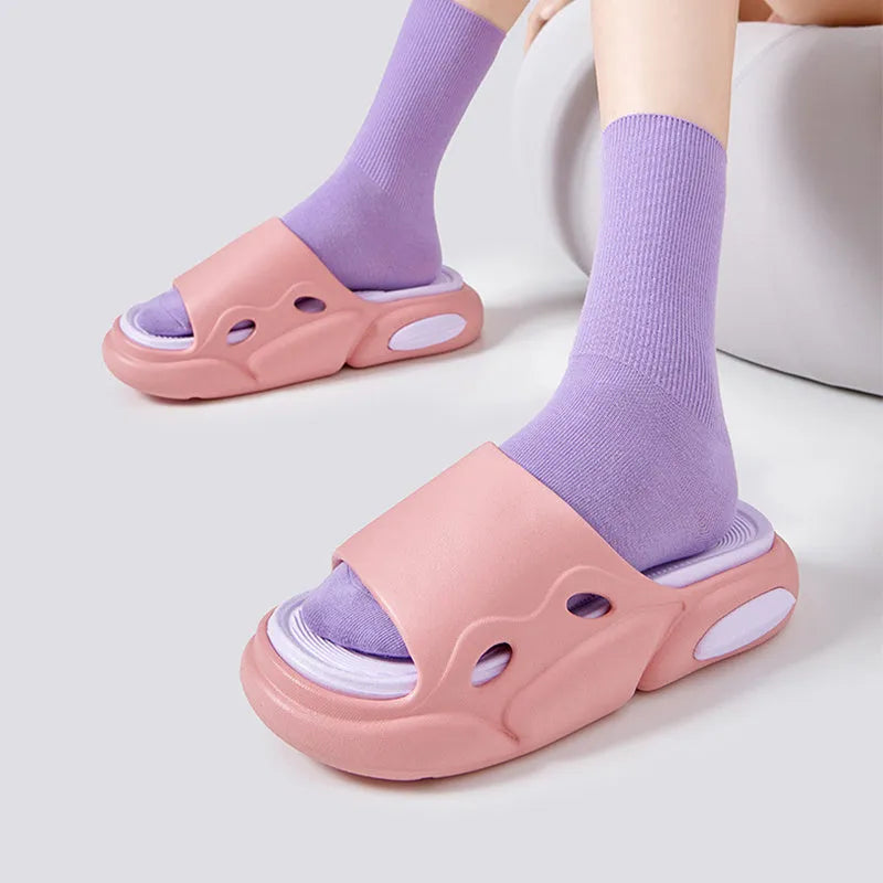 Pair of two-tone thick-soled EVA slippers with a leather lining, shown in pink and purple.