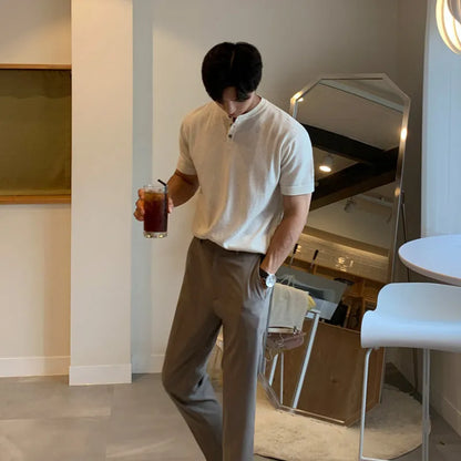 Man wearing a black slim-fit short-sleeved ice silk knit pullover shirt.