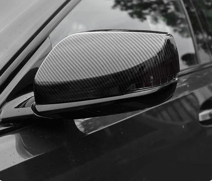 Pair of ABS plastic mirror covers for Cadillac CT5 CT6 in carbon fibre, silver, and rain frame finishes.