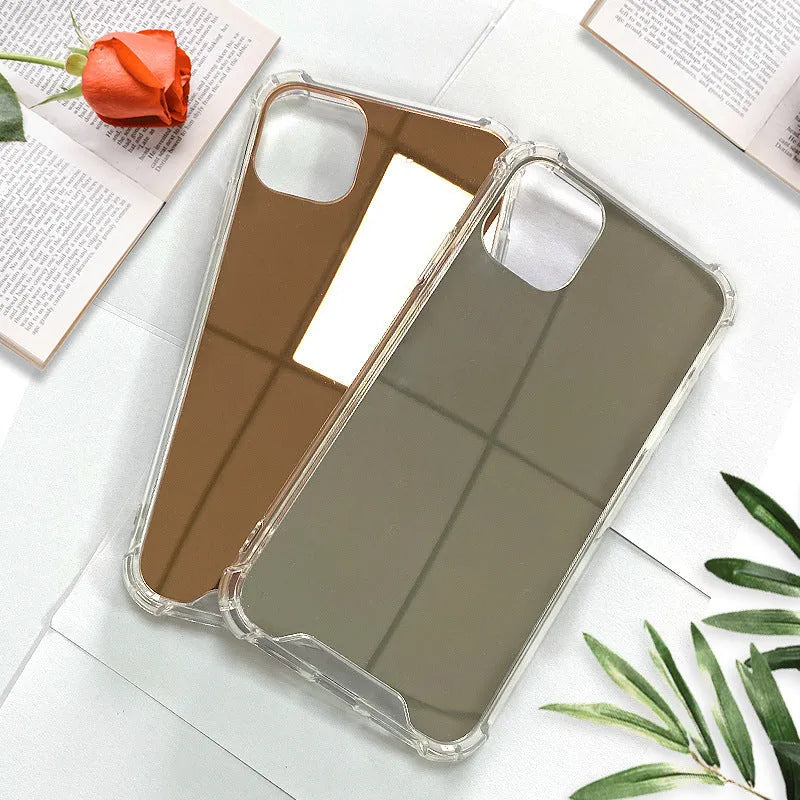 Silver mirrored phone case for Apple iPhone on a table, showing reflective back.