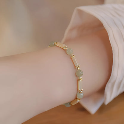 Women's Hetian jade bracelet with bamboo joint design on a white background.