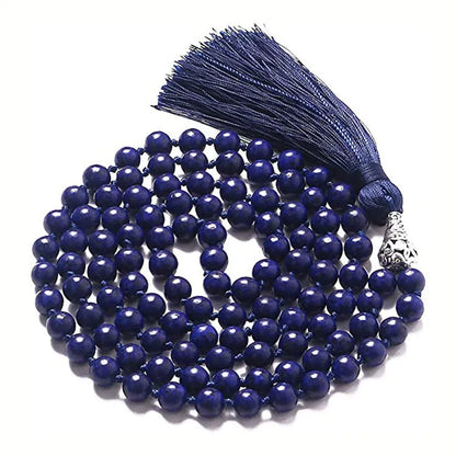 Long multi-coloured agate and stone tassel necklace with geometric beads on a white background.
