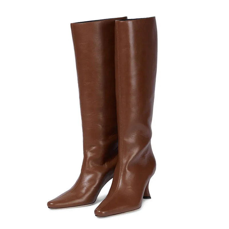 A pair of women's black square-toe cowboy boots made from microfiber leather.