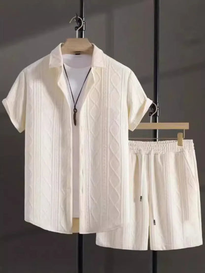 Man wearing a black and white jacquard short sleeve shirt and matching shorts suit set.
