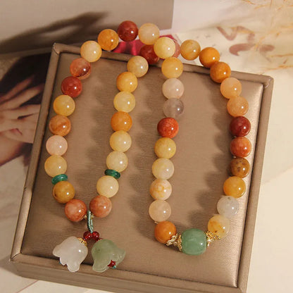 Natural green jade multi-strand bracelet with a silver-ton orchid charm for women.