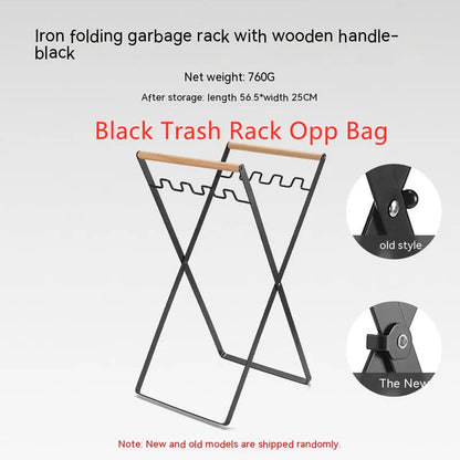 Black outdoor folding trash rack with wooden handle, holding a waste bag.