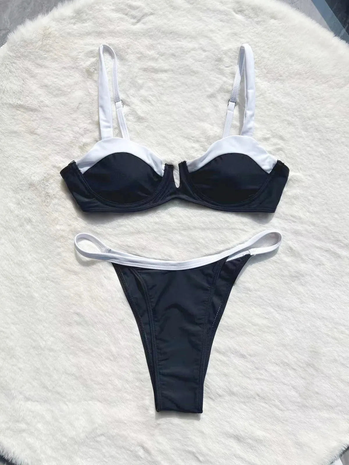 Women's black low waist bikini swimsuit with stitching detail and split brief design.