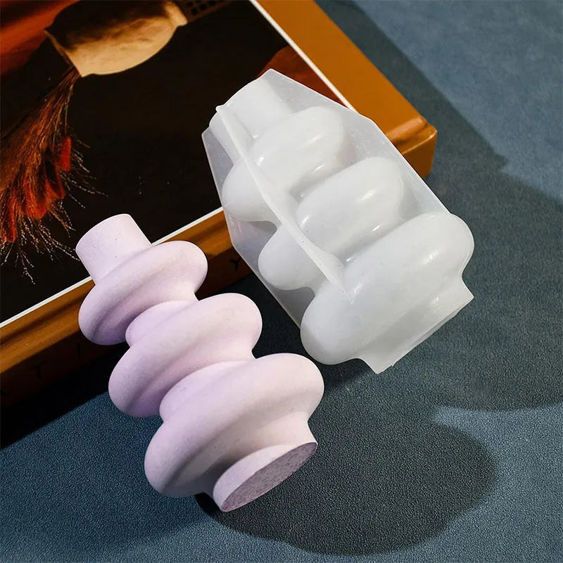 Silicone baking mould in shape of three-layer irregular circle vase on white background