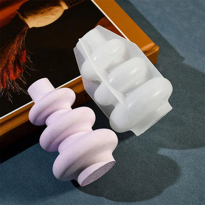 Silicone baking mould in shape of three-layer irregular circle vase on white background