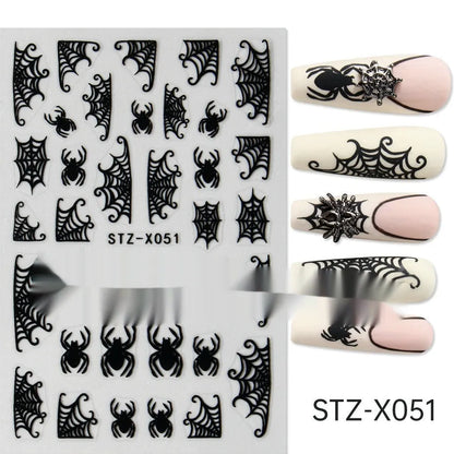 Assortment of black and silver nail sticker designs including cartoon and French tip patterns on a plastic sheet.