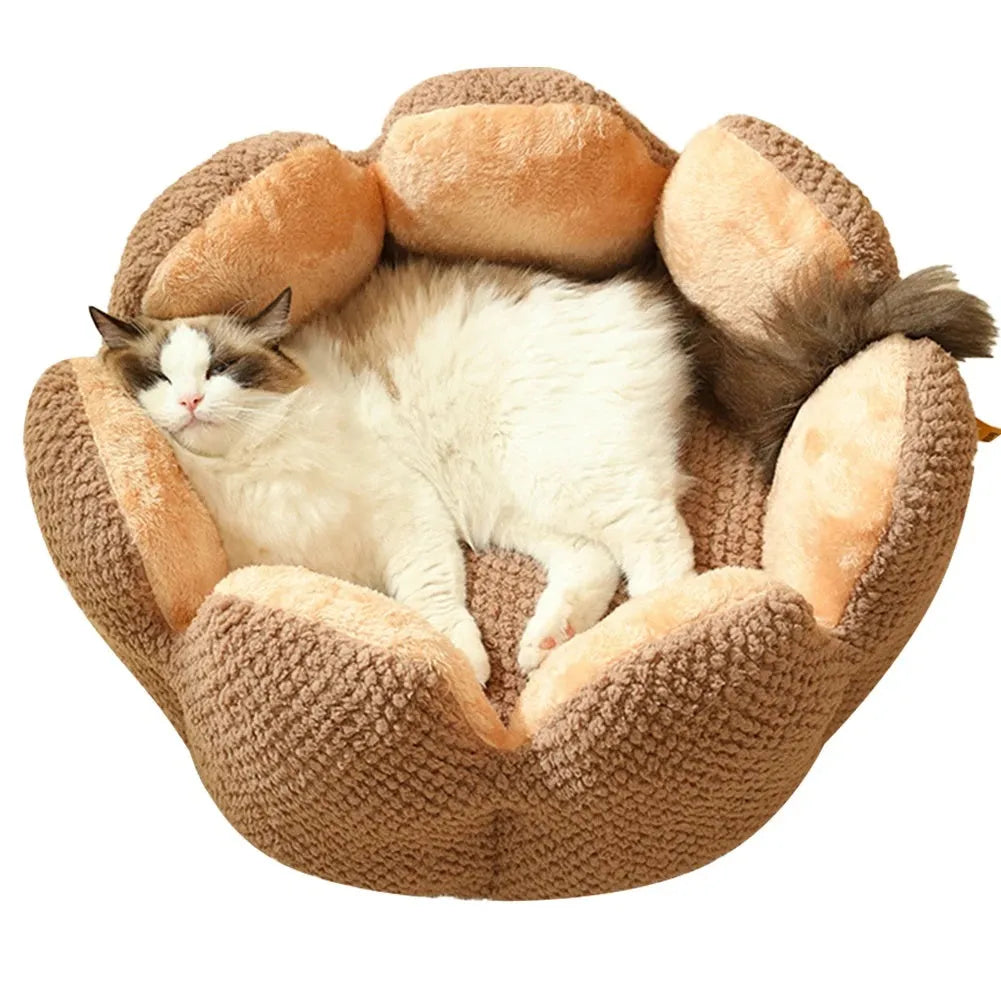 Green petal cactus-shaped plush cat bed with a cave-like opening on a wooden floor