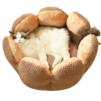 Green petal cactus-shaped plush cat bed with a cave-like opening on a wooden floor