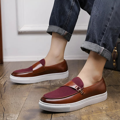 Men's black slip-on shoes with a gold horsebit buckle detail and round toe.