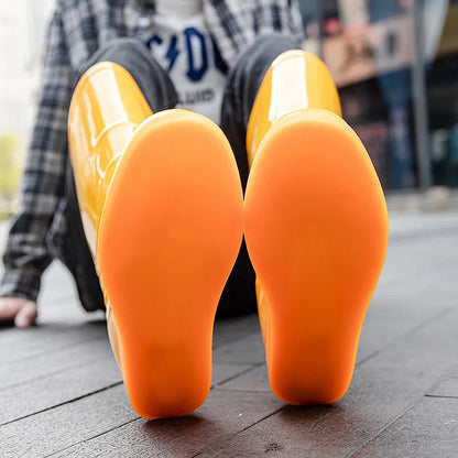 Plastic washable rain boots in white and yellow colours showing high tube Wellington-style design