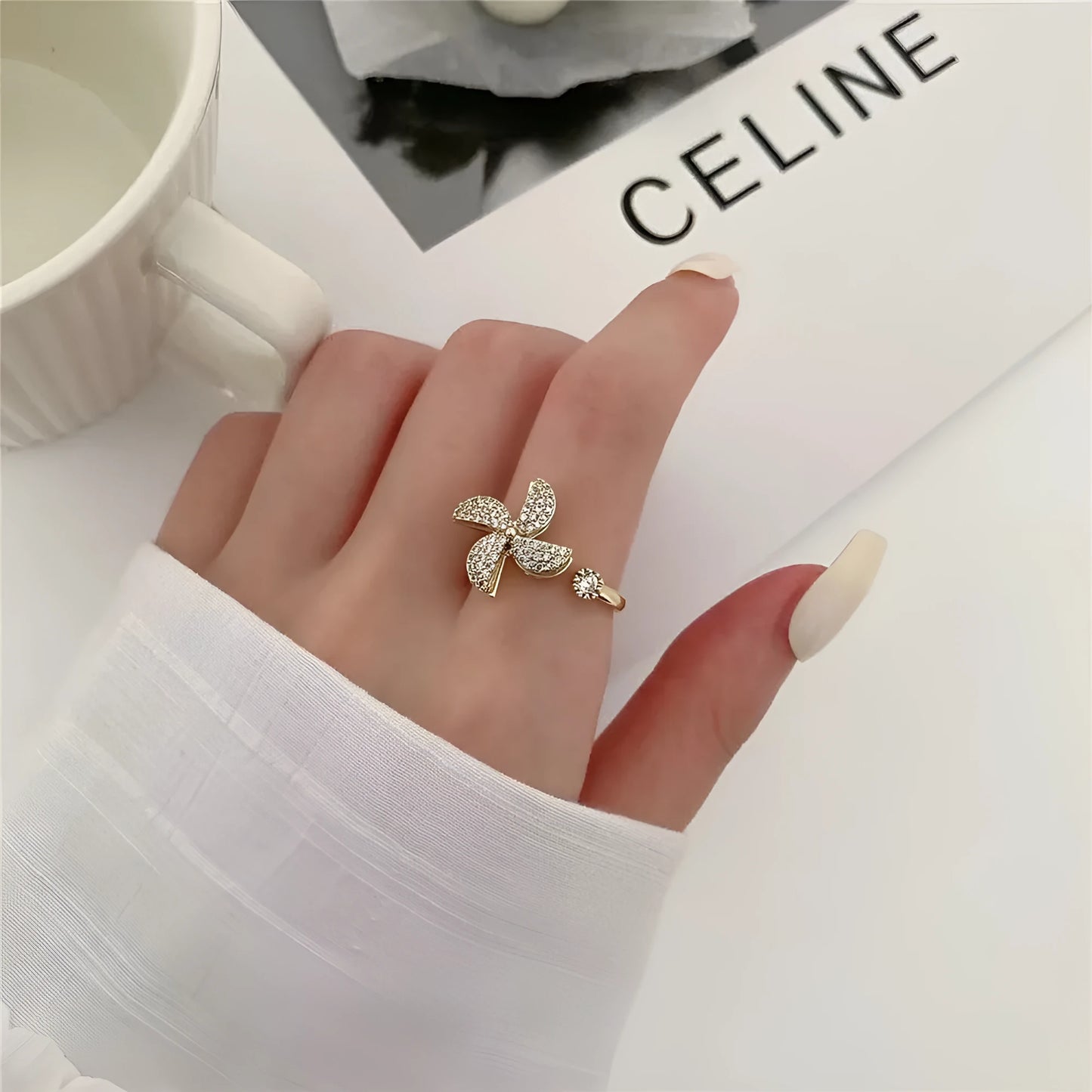 Gold and silver kinetic rings showing a geometric copper band with a central spinning windmill detail.