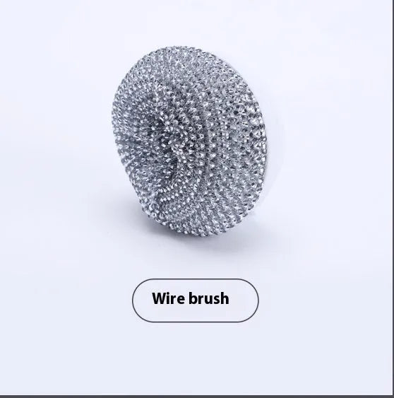 White cordless electric spin scrubber with multiple brush heads on a bathroom tile.