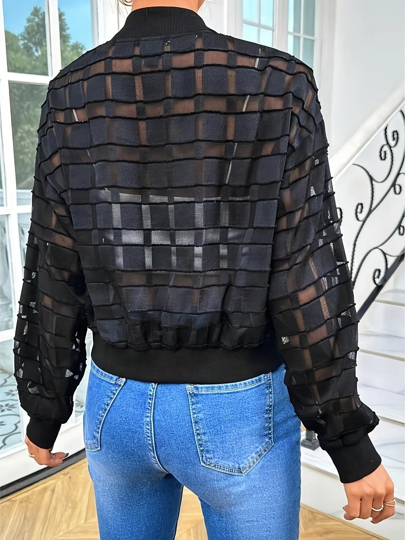 Black women's casual jacket with geometric pattern, long sleeves, and a full front zip.