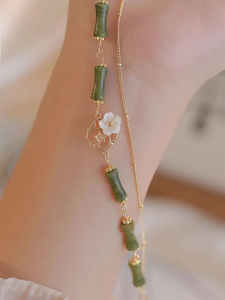 Natural olivine bracelet with Chinese double layer design featuring twin bells of Ireland olive branch elements