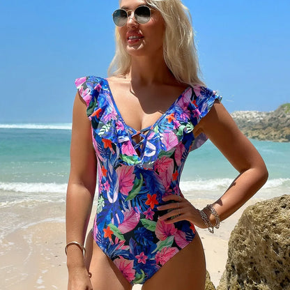 Blue women's ruffled bikini style one-piece swimsuit on a hanger.
