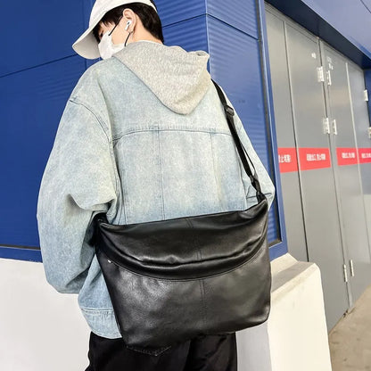 Men's brown vintage PU leather crossbody bag showing large main compartment and slim profile