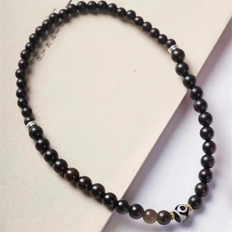 Tibet beads ebony bracelet showing two wooden circles on dark wood with 8mm diameter